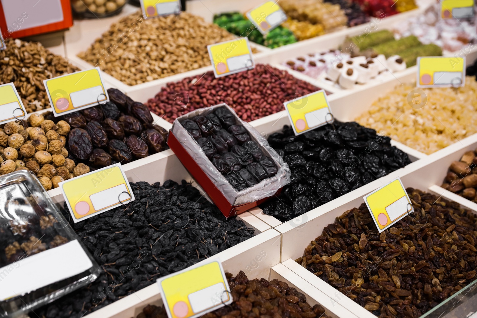 Photo of Assortment of delicious dried fruits and nuts at wholesale market