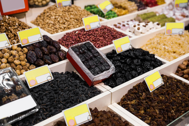 Photo of Assortment of delicious dried fruits and nuts at wholesale market