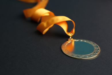 Photo of Gold medal on black background. Space for design