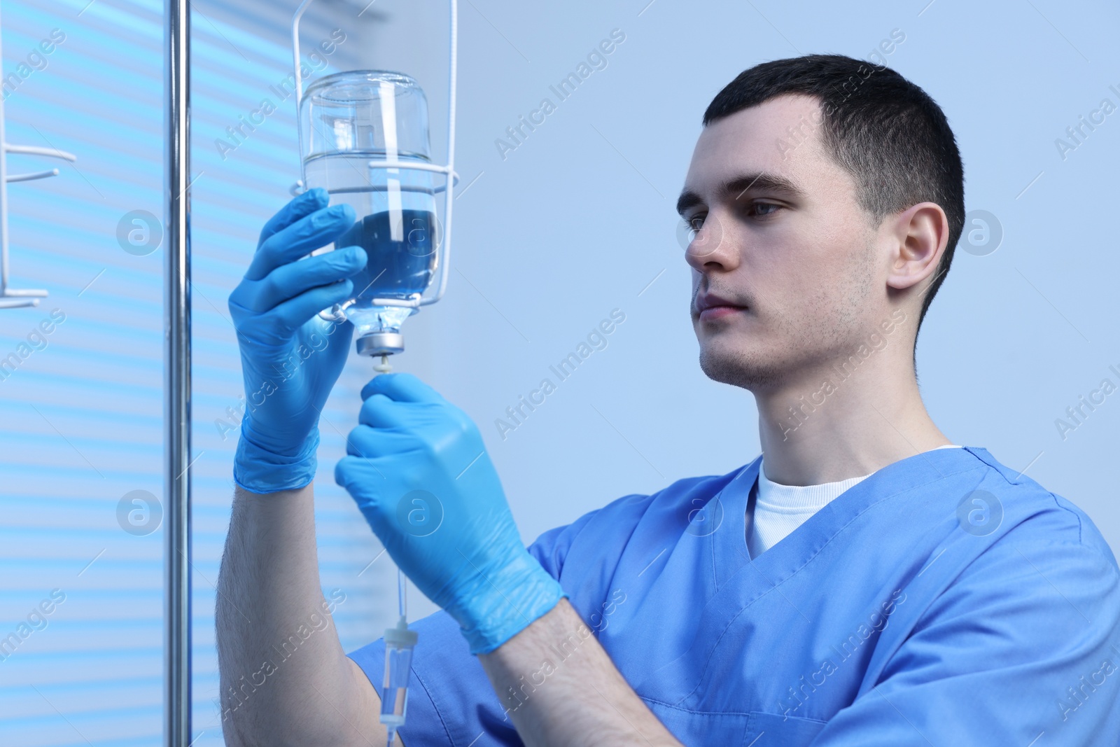 Photo of Nurse setting up IV drip in hospital