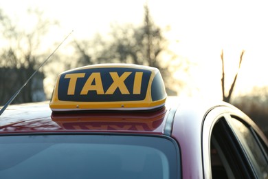 Photo of Roof light with word TAXI on car outdoors