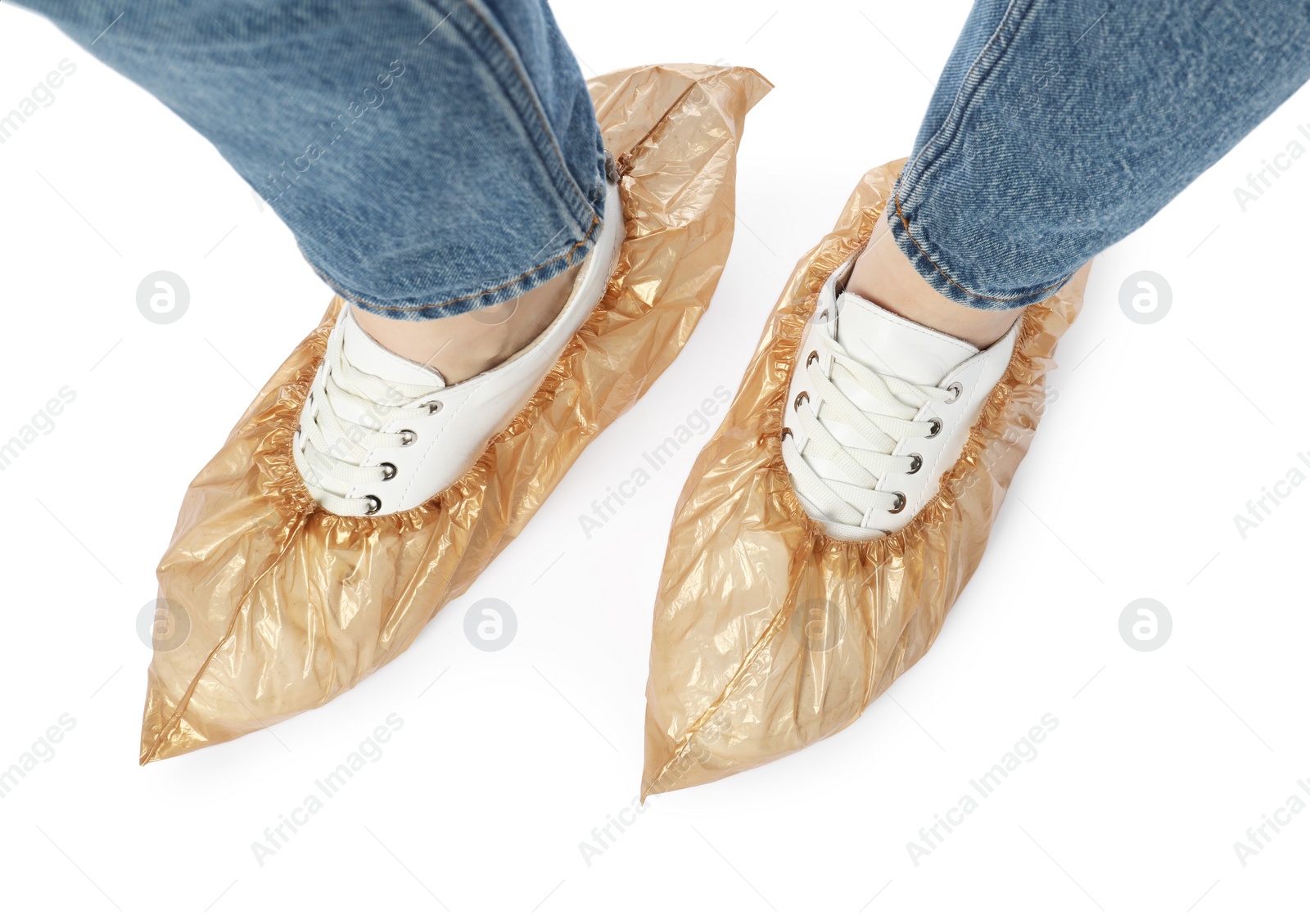 Photo of Woman wearing shoe covers onto her sneakers against white background, top view