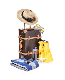 Suitcase, straw hat and other beach accessories isolated on white