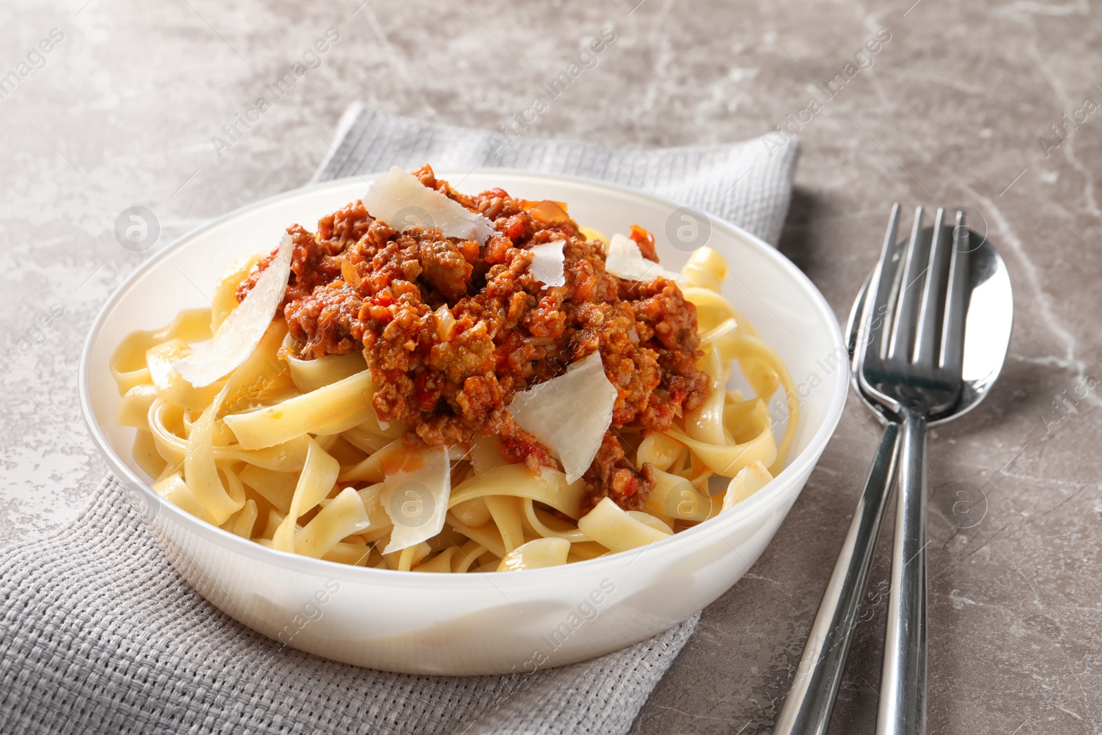 Photo of Plate with delicious pasta bolognese on table