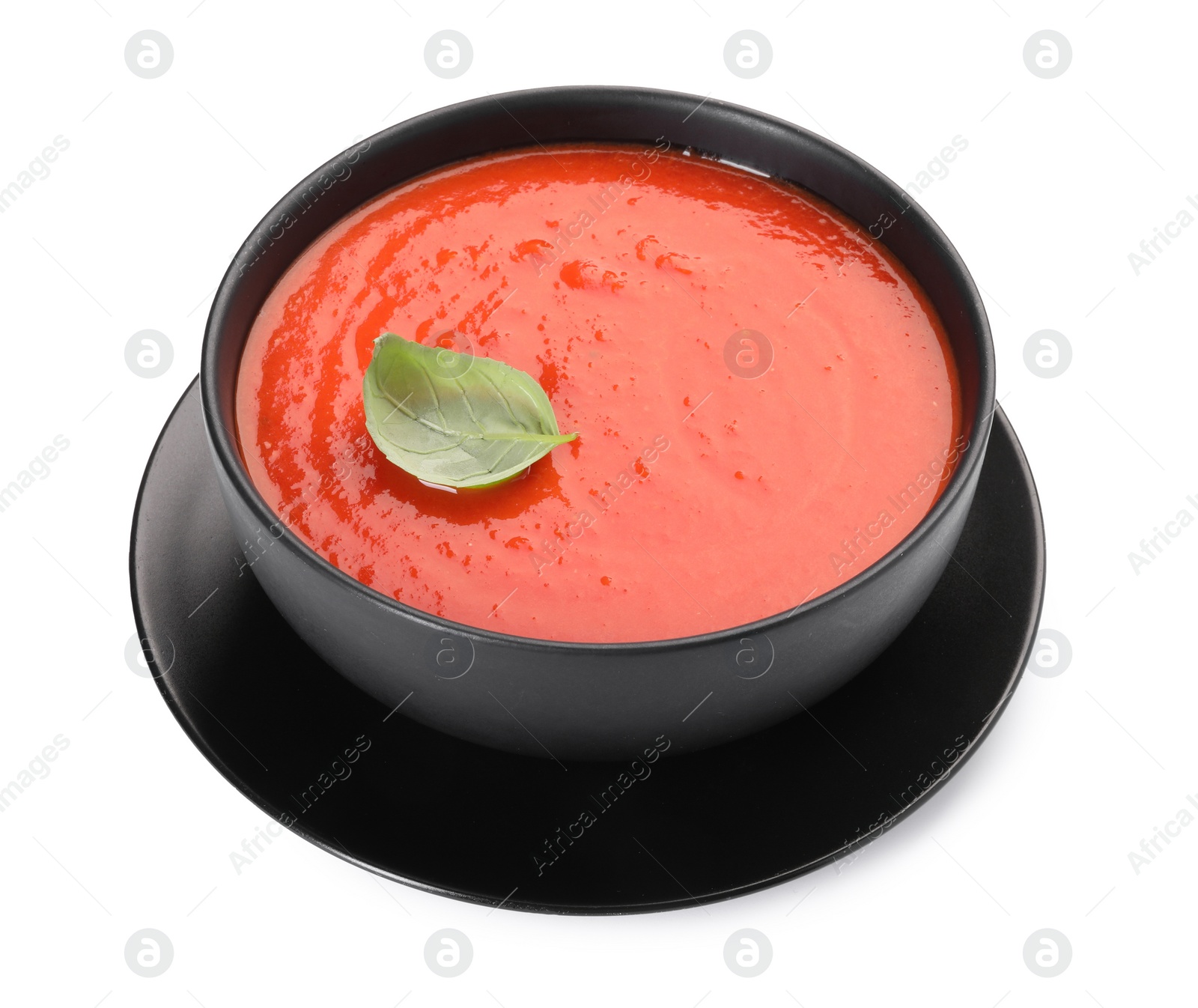 Photo of Delicious tomato cream soup in bowl isolated on white