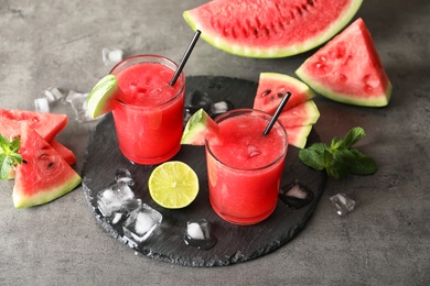 Photo of Tasty summer watermelon drink in glasses served on table