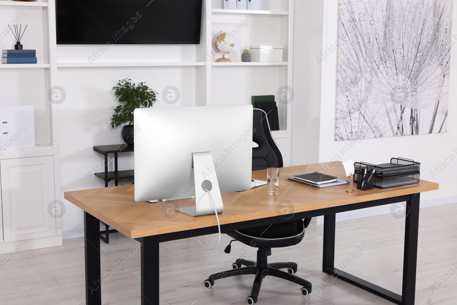 Photo of Stylish director's workplace with comfortable furniture in room. Interior design