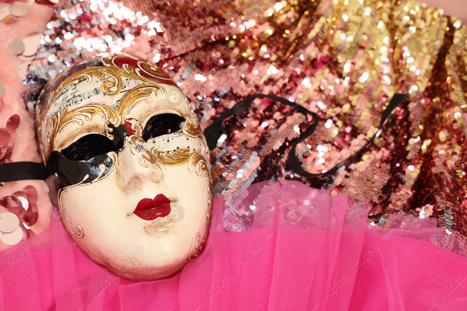 Photo of Carnival mask and beautiful pink costume with sequins, above view