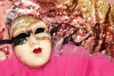 Photo of Carnival mask and beautiful pink costume with sequins, above view