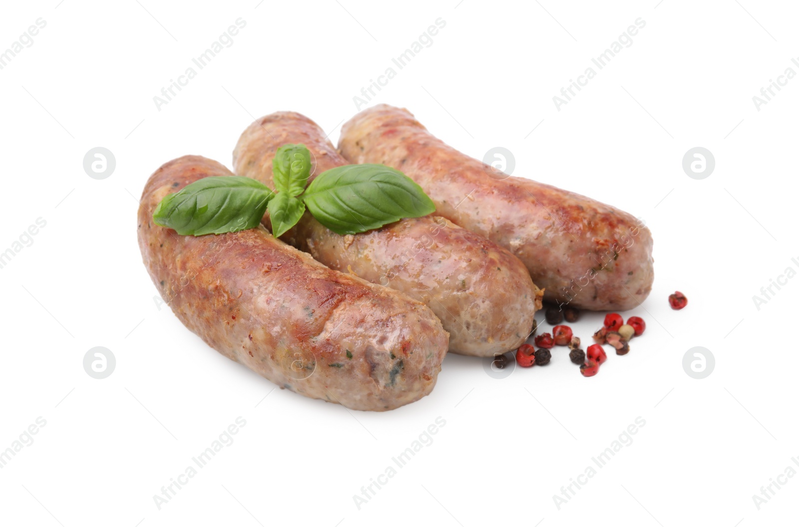 Photo of Tasty homemade sausages, peppercorns and basil leaves isolated on white