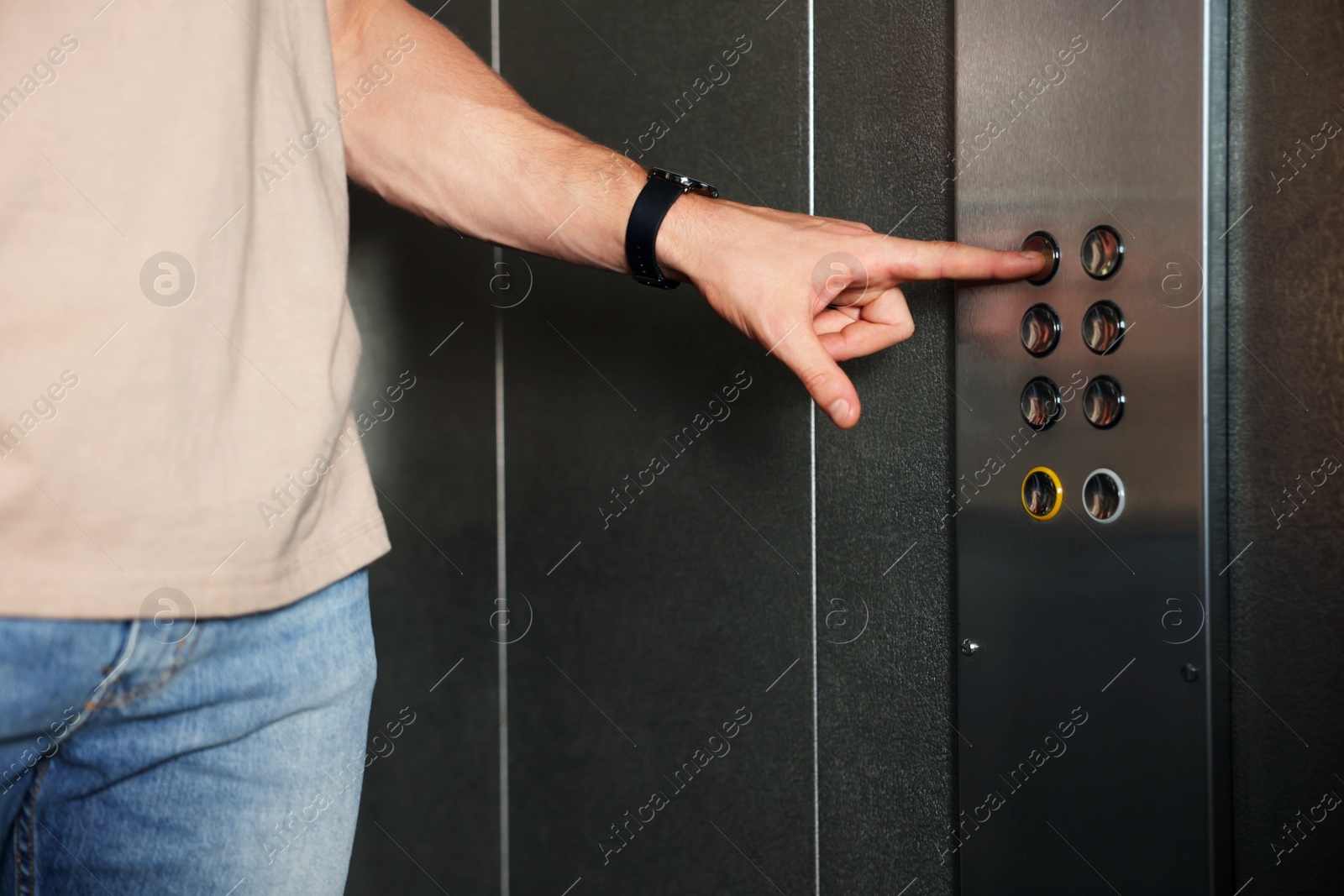 Photo of Man choosing floor in elevator, closeup view
