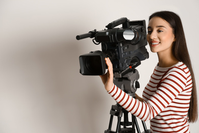 Photo of Operator with professional video camera on white background