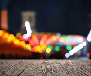 Image of Empty wooden surface against blurred lights. Bokeh effect 