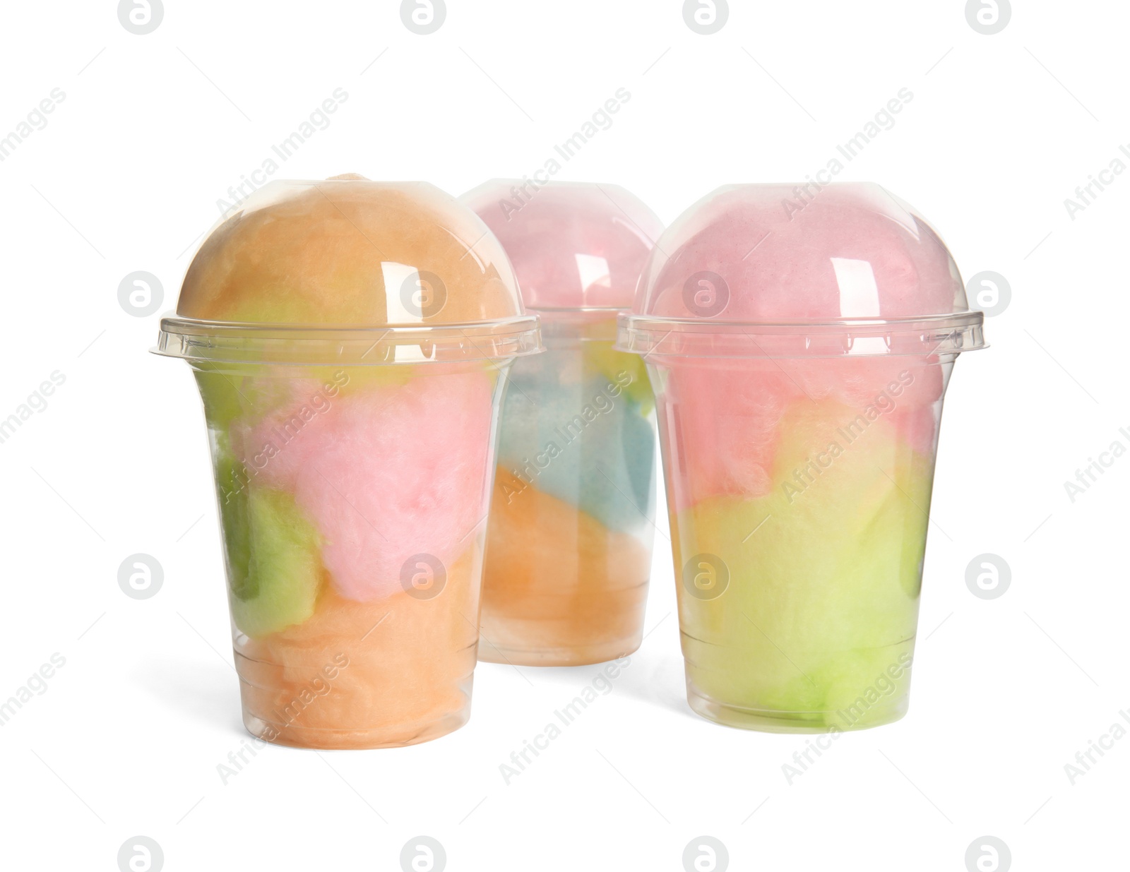 Photo of Plastic cups with tasty cotton candies on white background