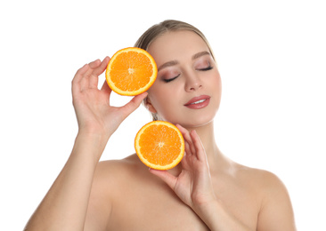 Young woman with cut orange on white background. Vitamin rich food