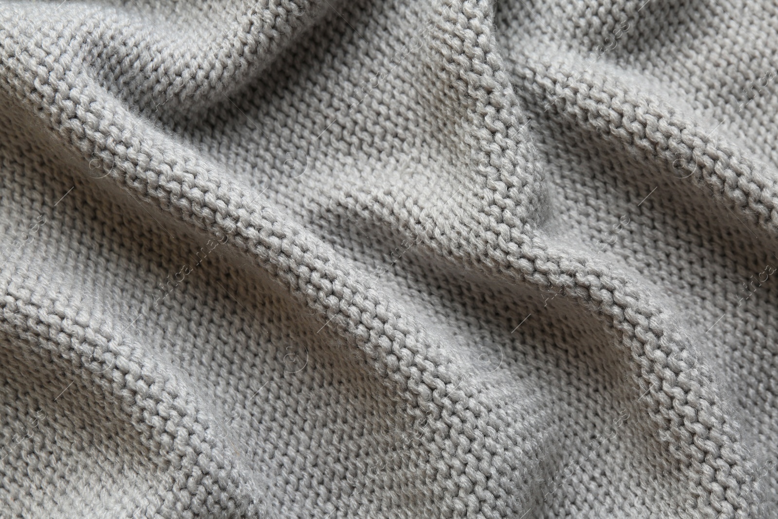 Photo of Beautiful grey knitted fabric as background, top view