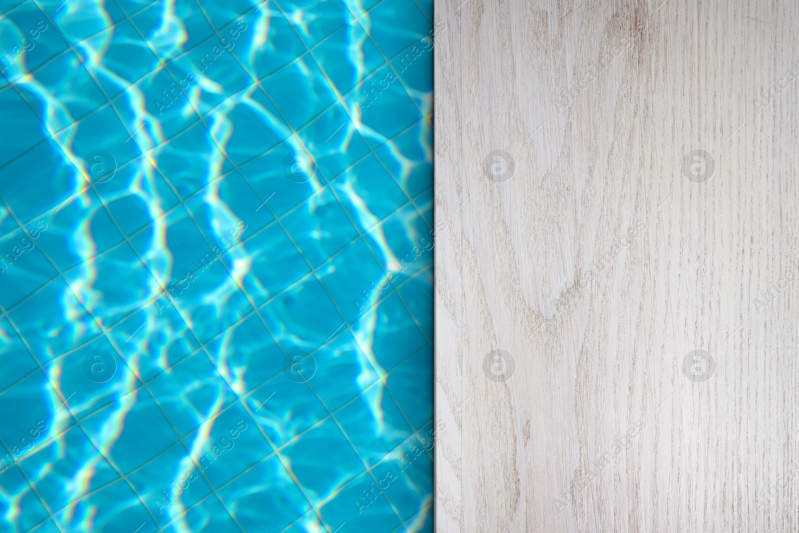 Image of Empty white wooden surface near swimming pool with clear water. Space for design