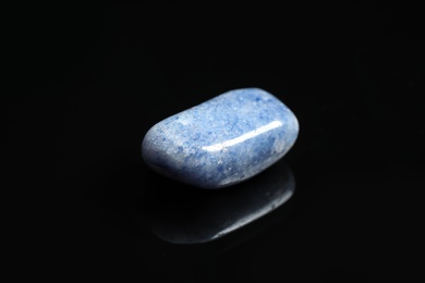 Photo of Beautiful blue quartz gemstone on black background