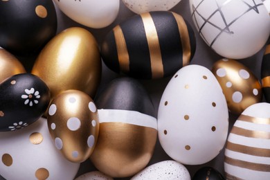 Photo of Beautifully painted Easter eggs as background, top view