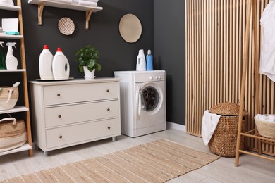 Photo of Laundry room interior with washing machine and furniture