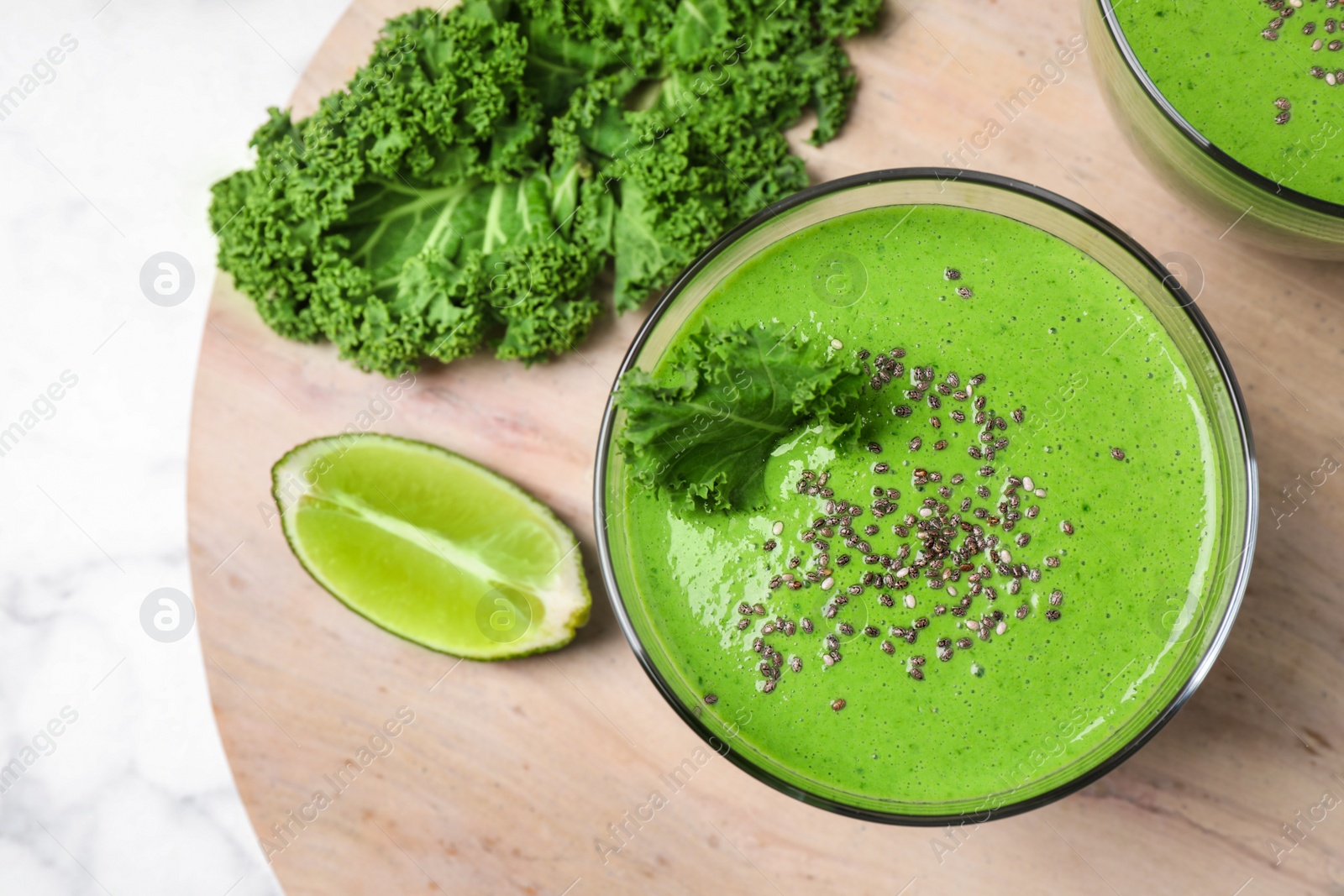 Photo of Tasty kale smoothie with chia seeds on table, flat lay