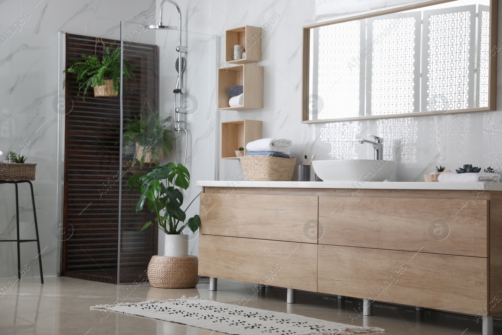 Photo of Bathroom interior with shower stall, counter and houseplants. Idea for design