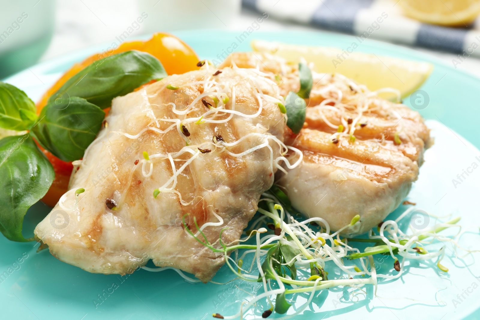 Photo of Tasty grilled fish with herbs on table, closeup