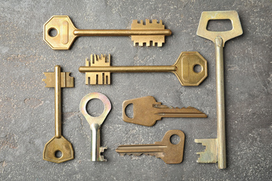 Photo of Steel keys on grey background, flat lay. Safety concept