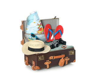 Photo of Open vintage suitcase with clothes and beach objects packed for summer vacation isolated on white