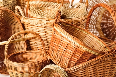 Photo of Many different wicker baskets made of natural material as background