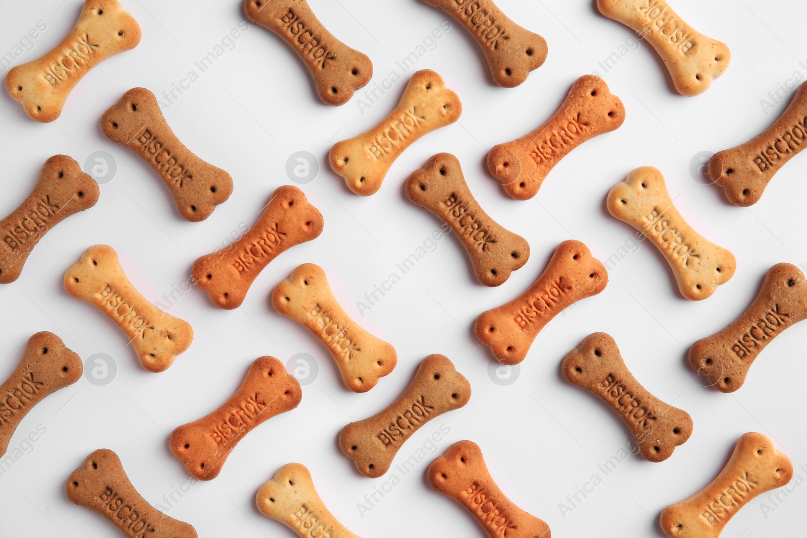 Photo of Bone shaped dog cookies on white background, top view