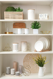 White shelving unit with dishes and different decorative stuff