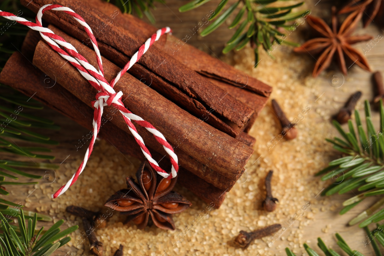 Photo of Different spices and fir branches on table, flat lay