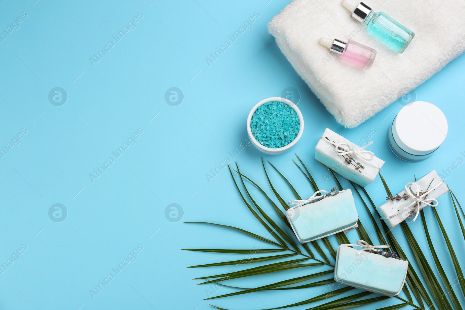 Photo of Flat lay composition with natural handmade soap on light blue background. Space for text