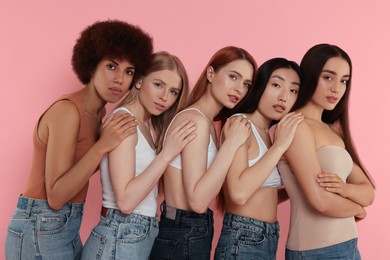 Photo of Portrait of beautiful young women on pink background