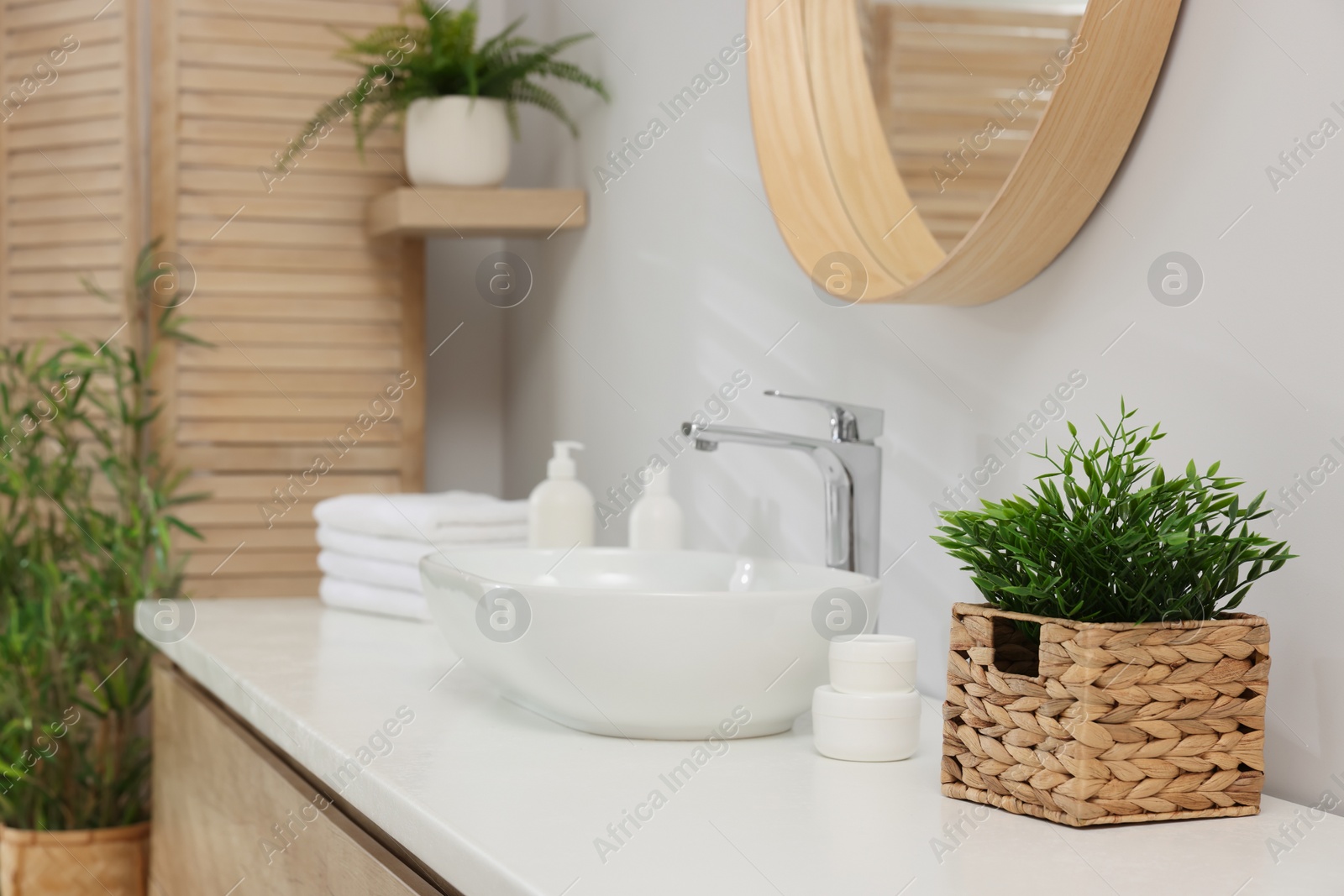 Photo of Different potted artificial plants in bathroom. Home decor