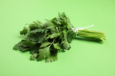 Photo of Bunch of fresh green parsley on color background