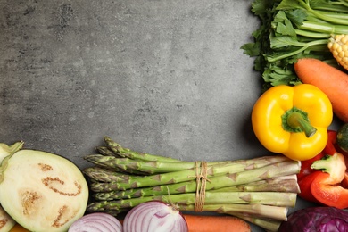 Photo of Flat lay composition with fresh vegetables and space for text on gray background