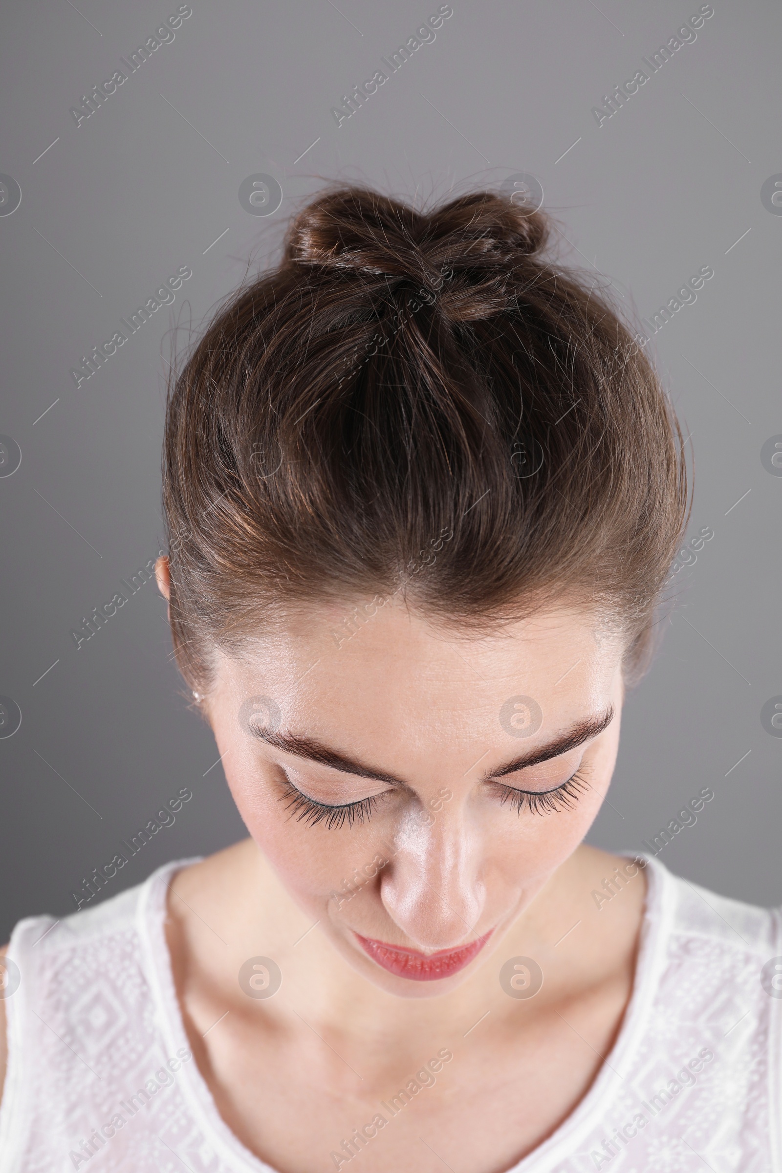 Photo of Woman with braided hair on grey background