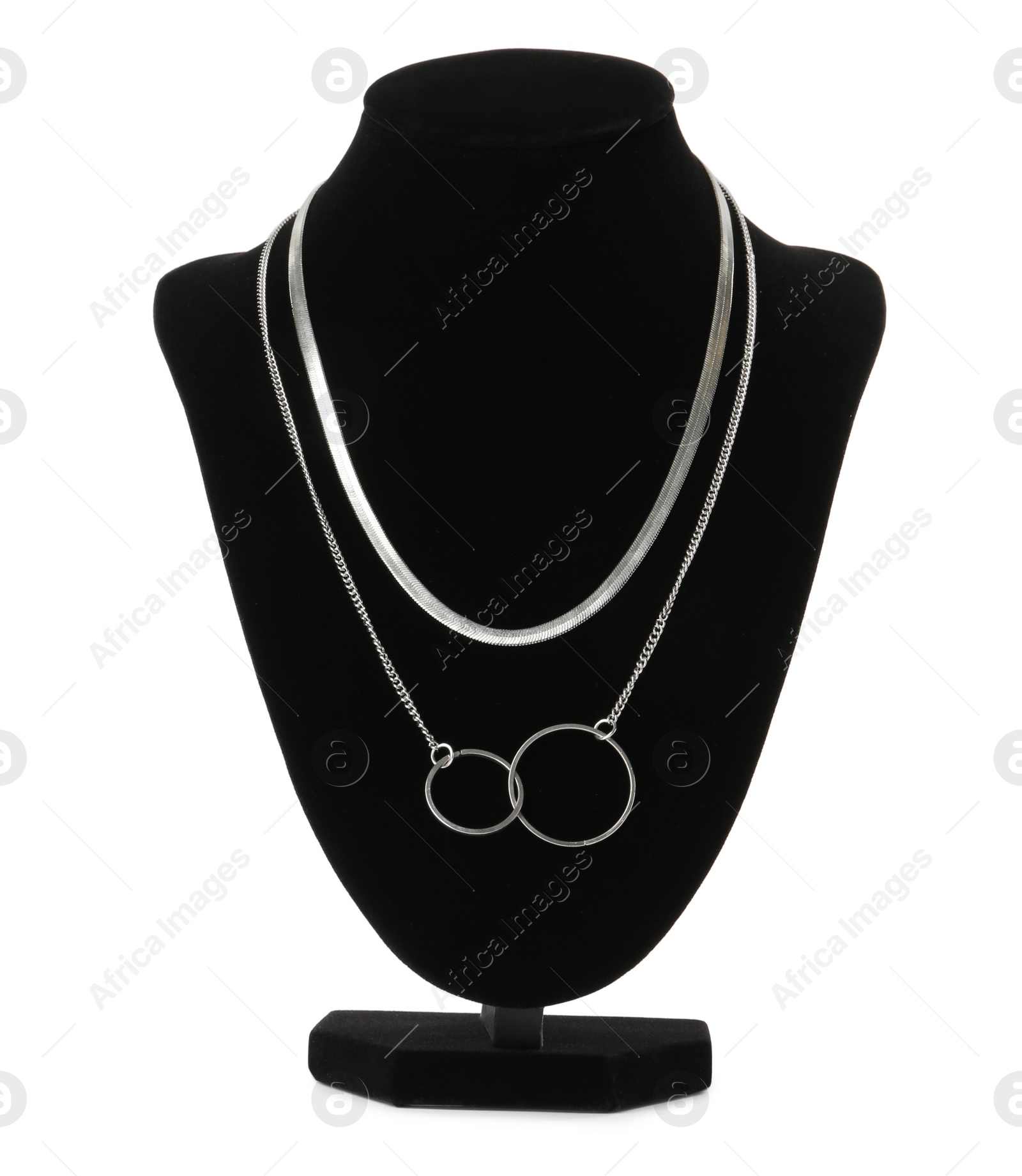 Photo of Stylish silver necklace on jewelry bust against white background