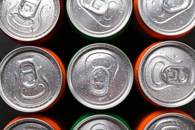 Photo of Energy drink in wet cans, top view. Functional beverage