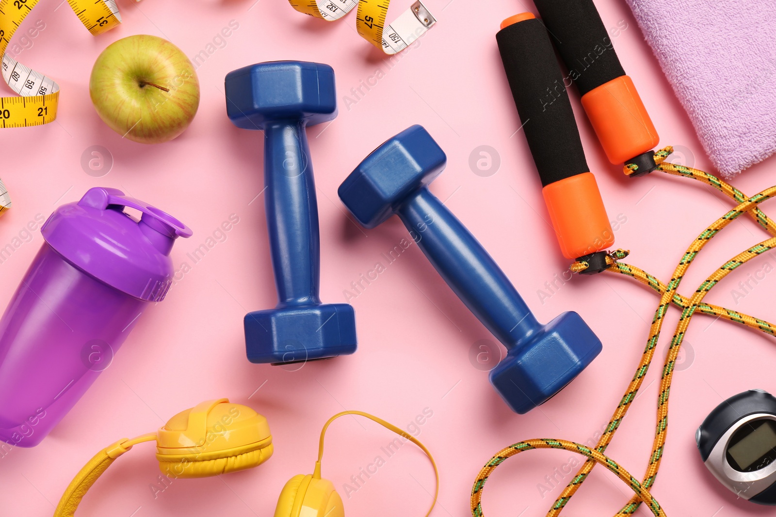 Photo of Flat lay composition with dumbbells on pink background