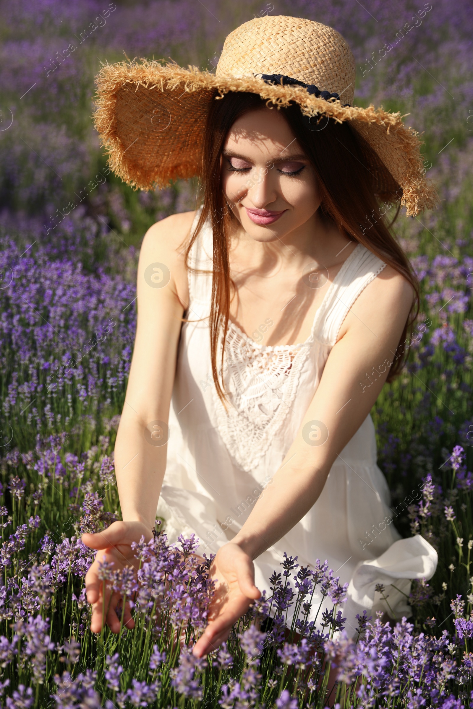 Photo of Young woman in lavender field on summer day