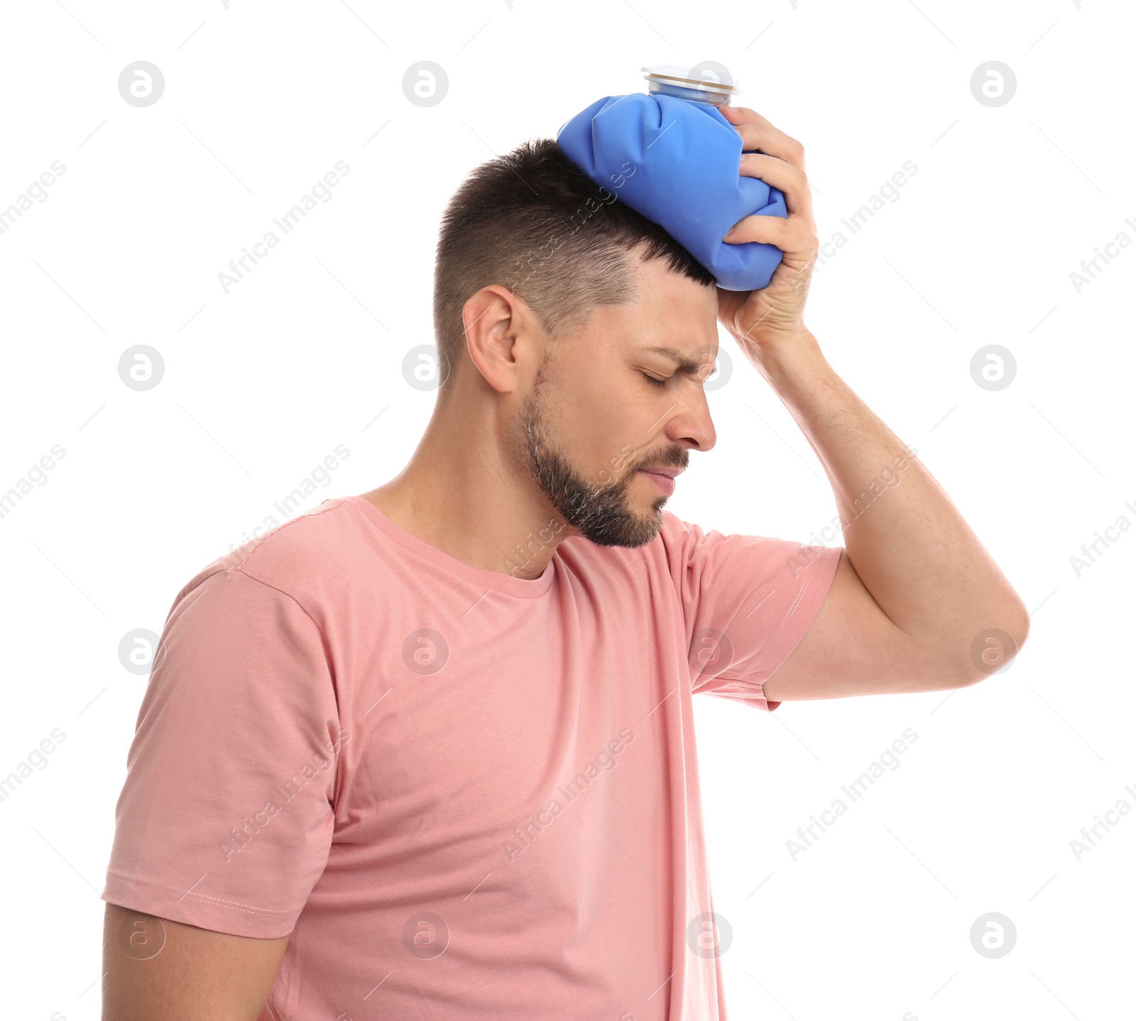 Photo of Unhappy man using cold pack to cure headache on white background