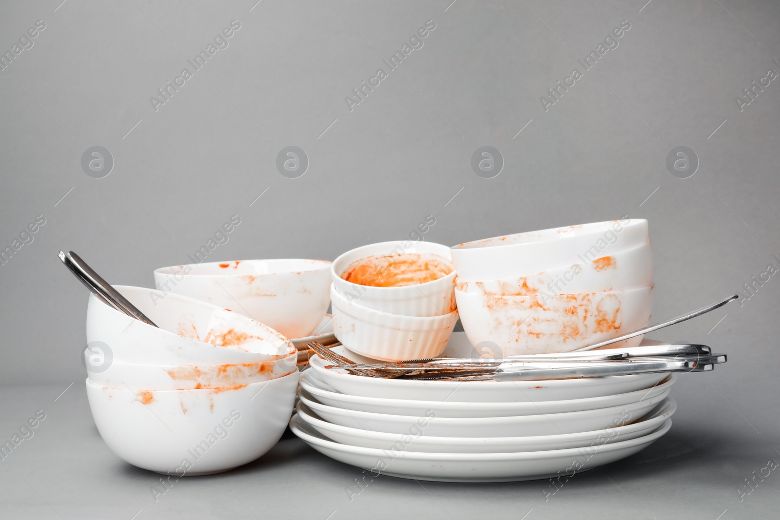 Photo of Set of dirty dishes on grey background