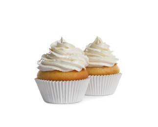 Delicious cupcakes decorated with cream on white background