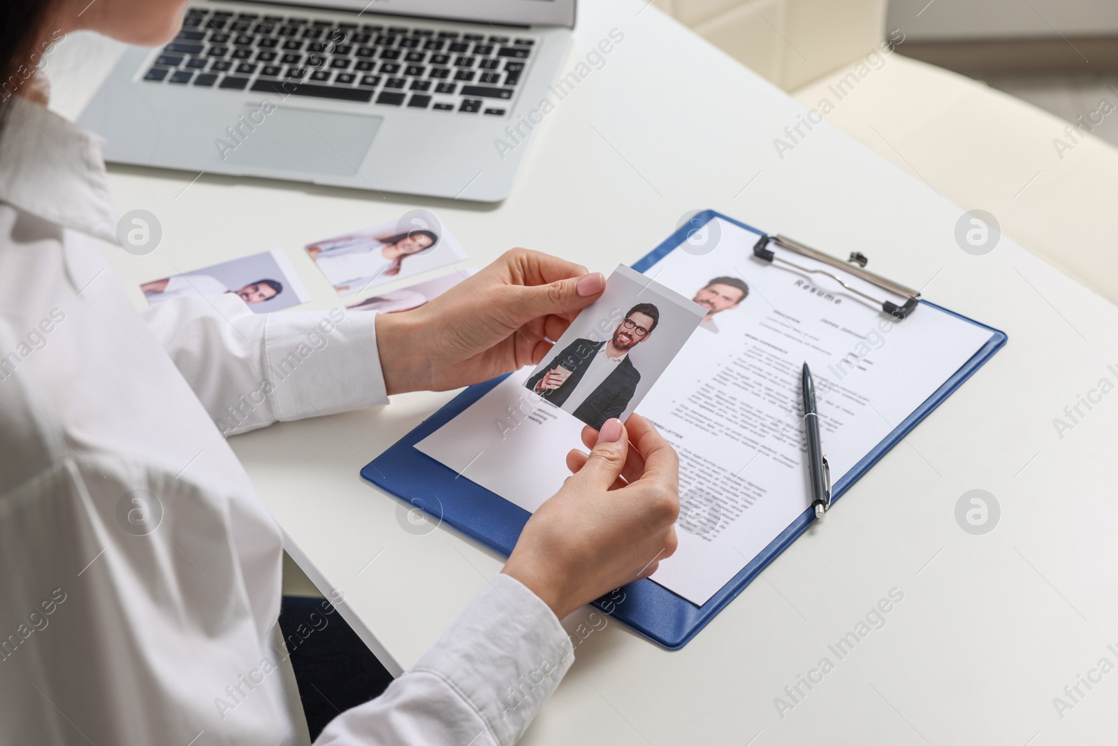 Photo of Human resources manager choosing employee at table, closeup