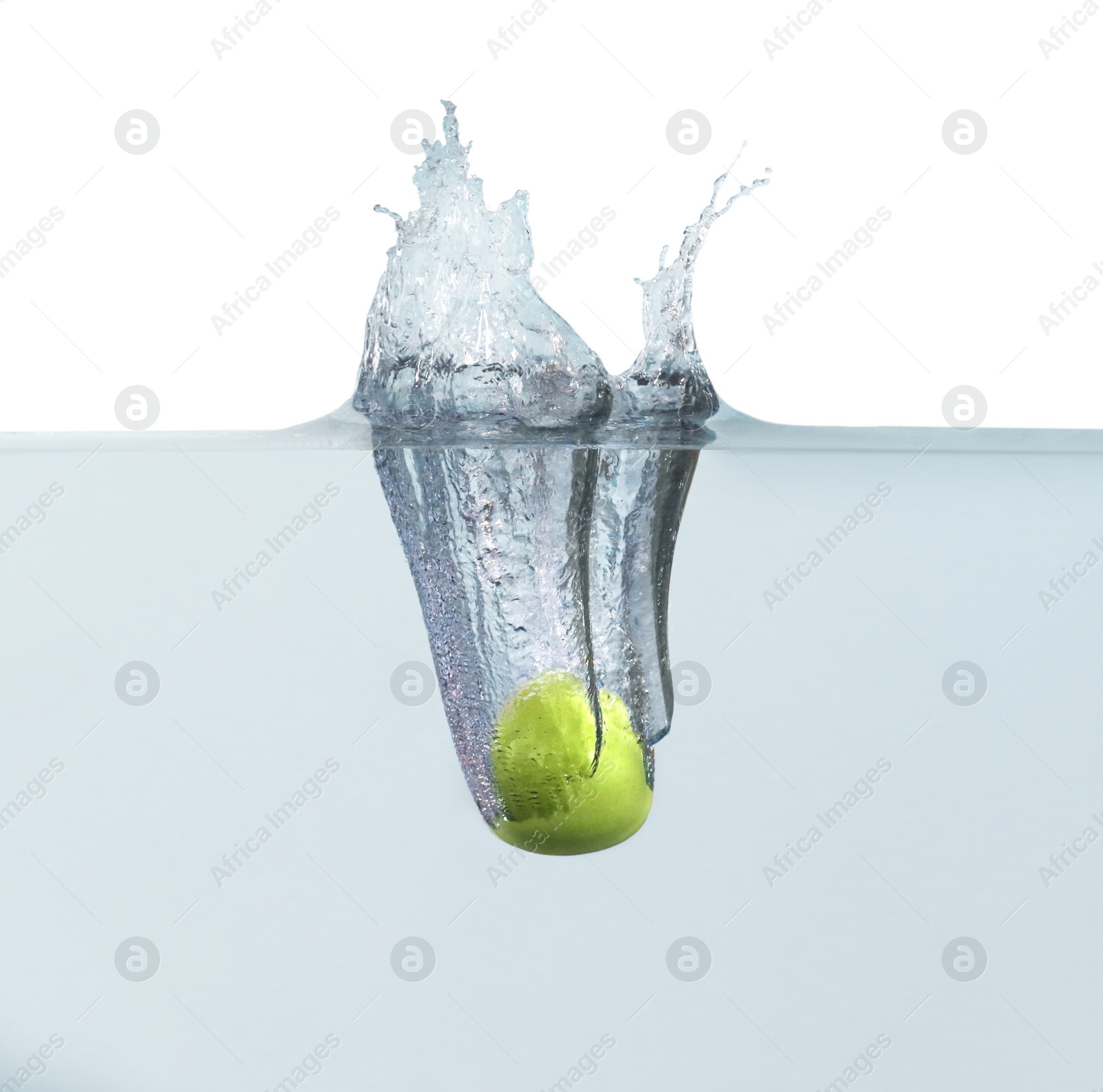 Photo of Ripe green apple falling down into clear water with splashes against white background