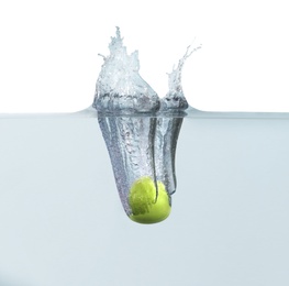 Ripe green apple falling down into clear water with splashes against white background