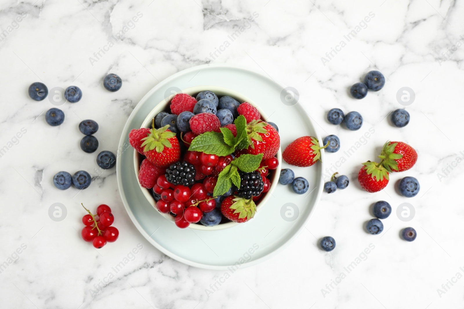 Photo of Mix of ripe berries on white marble table, flat lay